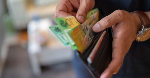 Person's hand holding a wallet with cash - Advantages of SMSF - Advivo Business Advisors and Accountants Blog Image
