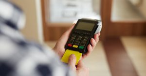 A Person Inserting an ATM to a Credit Card Payment Terminal - Money-Saving Tips From Our Clients - Advivo Business Advisors and Accountants Blog Image