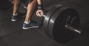 A man lifting a weight at the gym - Advivo newsletter image