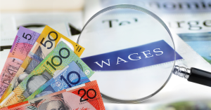 Australian dollars with wages and a magnifying glass - Wage increase - Advivo blog image
